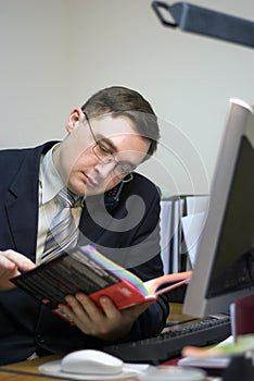 Office man is reading a book