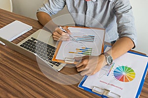 Office man using pen to check the document