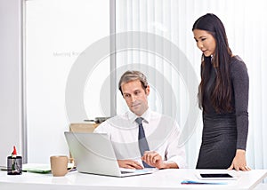 Office, man and woman at laptop for advice, teamwork and planning for online startup review at desk. Computer, website