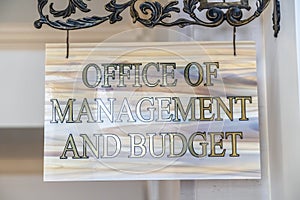 Office Of Management And Budget sign hanging on decrative wrought iron hanger photo