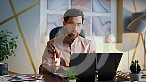 Office manager videocalling laptop sitting desktop closeup. Man video conference
