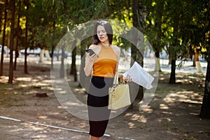 An office manager woman goes to work, talks on the phone and looks into the documents