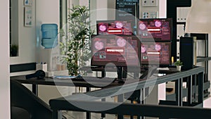 IT office with multiple monitors showing critical error message flashing on screens