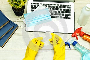 Office object : cleaning product on wood table with medical mask and gel and laptop. Professional cleaning products, spring cleani