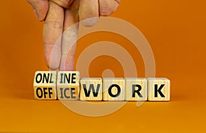 Office or online work symbol. Businessman turns cubes and changes words `online work` to `office work`. Beautiful orange