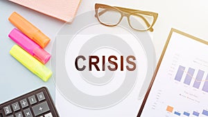 Office paper with the word Crisis. The exit from the crisis and financial stability. Focus on resolving the midlife crisis. The