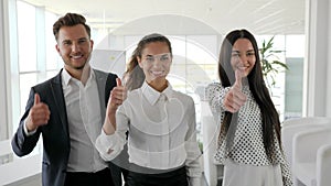 Office people with thumbs up at boardroom, three managers showing positive gesture close-up, multinational business