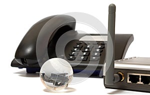 Office phone, wi-fi router and glass globe