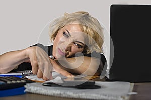 Office portrait of young sad and depressed business woman working lazy at laptop computer desk feeling bored and tired looking tho
