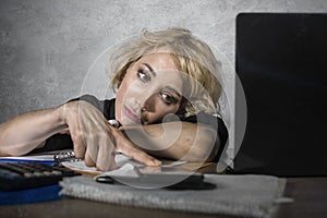 Office portrait of young sad and depressed business woman working lazy at laptop computer desk feeling bored and tired looking tho