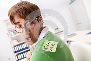 The office prank with kick me message on sticky note