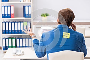 The office prank with kick me message on sticky note