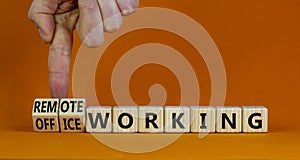 Office or remote working symbol. Businessman turns cubes and changes words `remote working` to `office working`. Beautiful ora