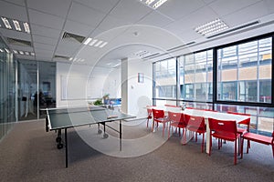 Office room with table, chairs and ping pong table