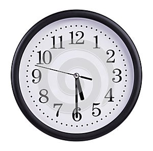 Office round clock shows half past five