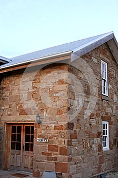 The Office - sandstone house with side door and windows