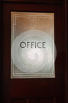 Office sign on door glass in art deco style