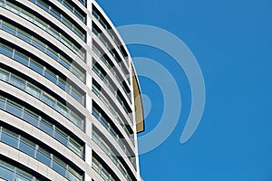 Office skyscraper high business building on blue sky background, looking up to glass modern building