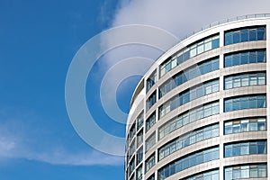 Office skyscraper high business building on blue sky background, looking up to glass modern building