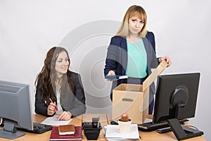 Office staff member with a smile watching charges fired colleagues