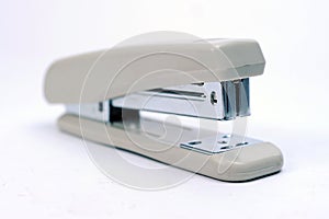 Office stationary Gray stapler with pile of staples