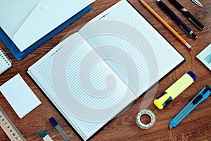 Office Supplies Arranged Around Notebook on Desk