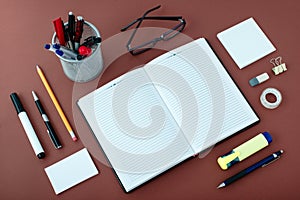 Office Supplies Arranged Around Notebook on Desk