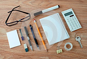 Office Supplies Arranged Around Notebook on Desk