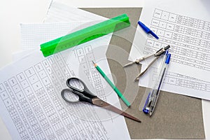 Office supplies lie on papers on which tables with many calculations and numbers are printed.