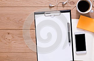 Office supplies and mobile phone at wood background