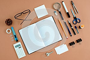 Office Supplies Neatly Organized Around Notebook