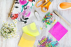 Office Supplies on White Wooden Work Desk With Flowers