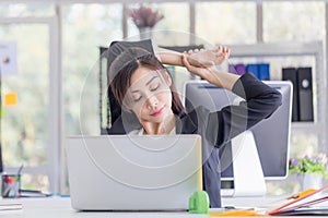 Office syndrome, Asian woman doing stretch exercise stretching her arms in work time, Female officer feeling tired and fatigue