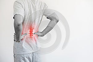 Office syndrome, Backache and Lower Back Pain Concept. a man touching his lower back at pain point