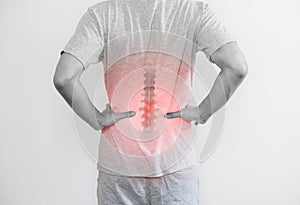 Office syndrome, Backache and Lower Back Pain Concept. a man touching his lower back at pain point