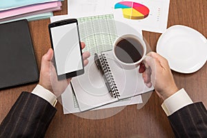 Office table with accessories, folders and documents, cup of coffee