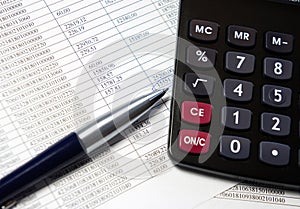 Office table with calculator, pen and accounting document