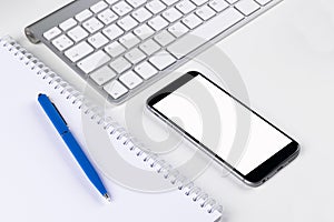 Office table with computer, wireless computer keyboard, tablet smartphone.copy space notebook. empty screen