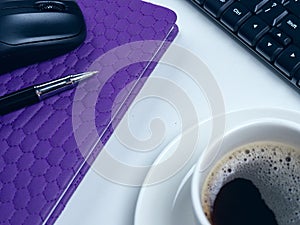 Office table desk. Workspace with note book, keyboard, office supplies and coffee cup on white background.