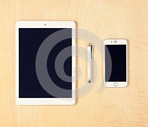 Office table with digital tablet and smartphone. View from above