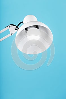 Office table lamp on blue background with space for text and idea concept