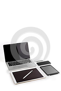 Office table with laptop computer, digital tablet, smartphone, p