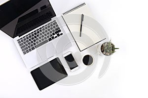 Office table with laptop computer, notebook, digital tablet and smartphone on white background