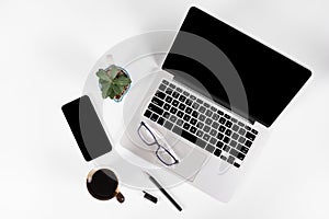 Office table with laptop computer, smartphone, pen, notebook and coffee on isolated pure white background / Laptop and tablet mock