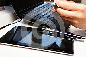 Office table with laptop and female hands