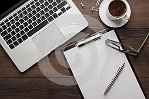 Office table with notepad and computer