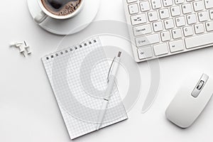 Office table with notepad, computer and coffee cup