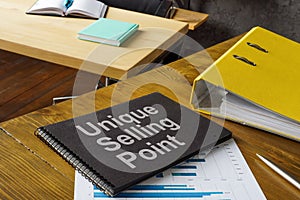 Office table and notepad with USP unique selling point. photo