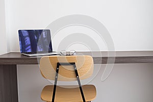 Office table white laptop, modern chair and modern eyeglasses. c