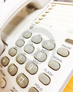 Office telephone , gray keypad in white classic telephone. This is a device for officer to contact with others
